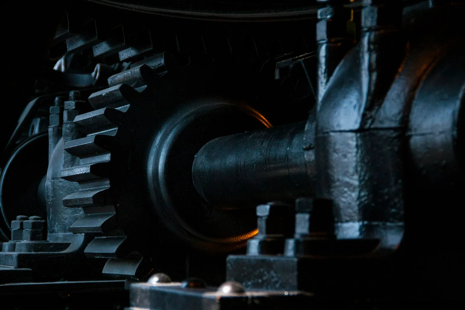 Close-up of black metal gears on an industrial machine