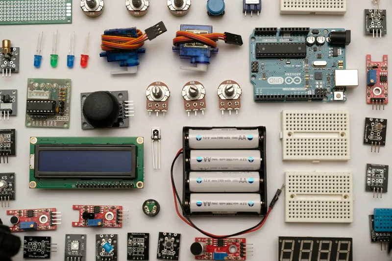 Electronic components, a microcontroller board and sensors laid out on a table