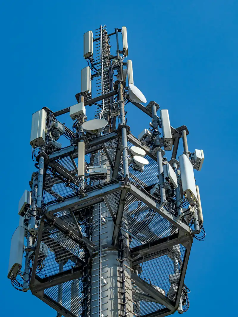 Tall telecommunications tower with many antennas