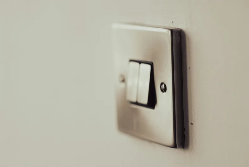 White light switch on a white painted wall
