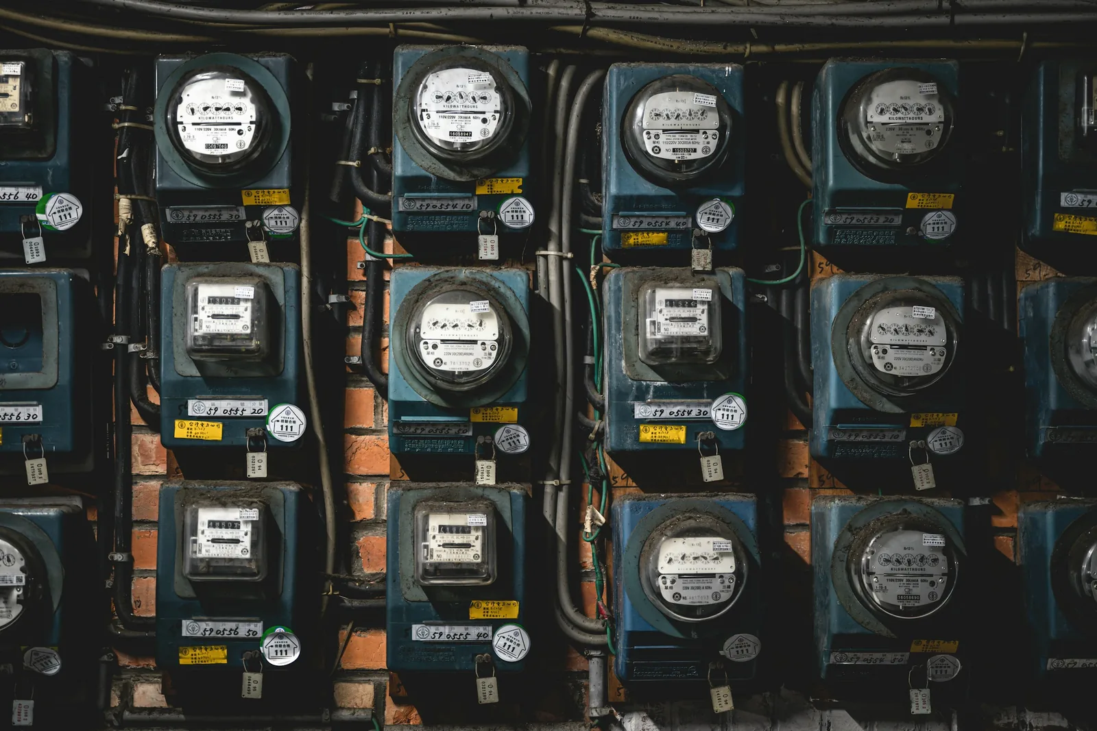 Rows of electricity meters stacked on a wall
