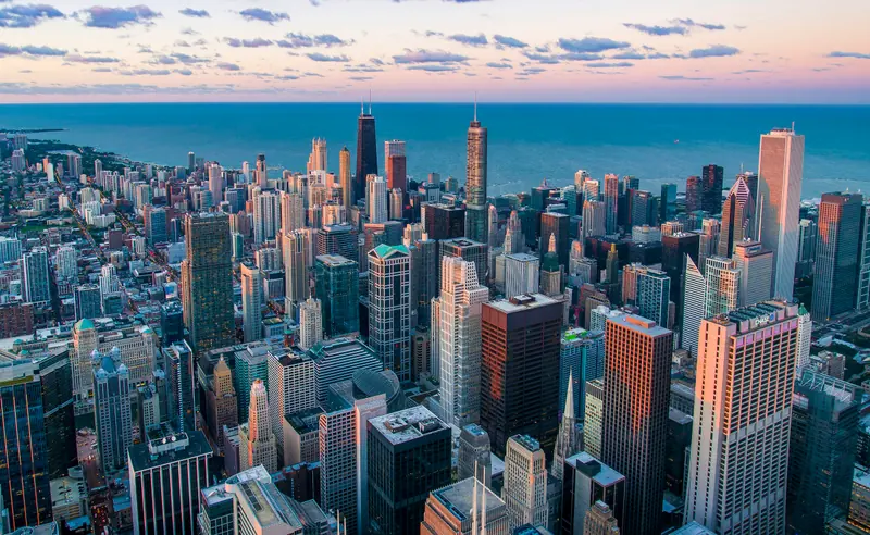 Aerial view of a dense city skyline by a lake