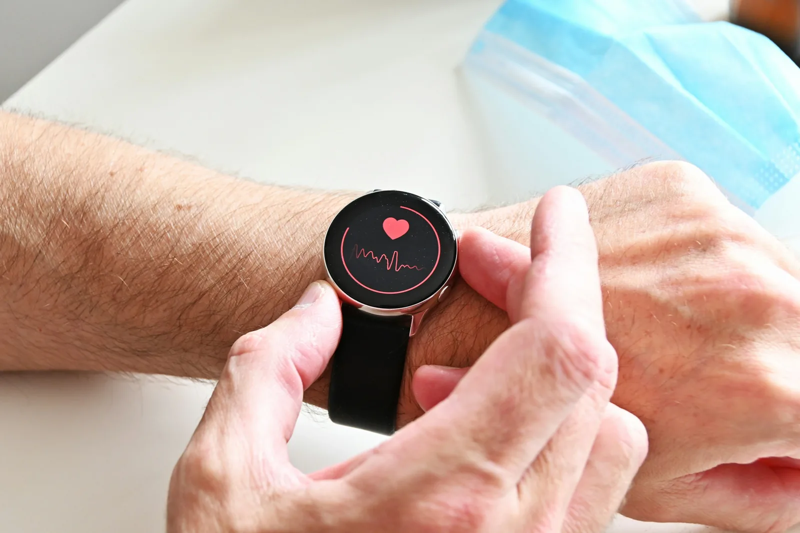 A person checking the heart-rate monitor on a smartwatch